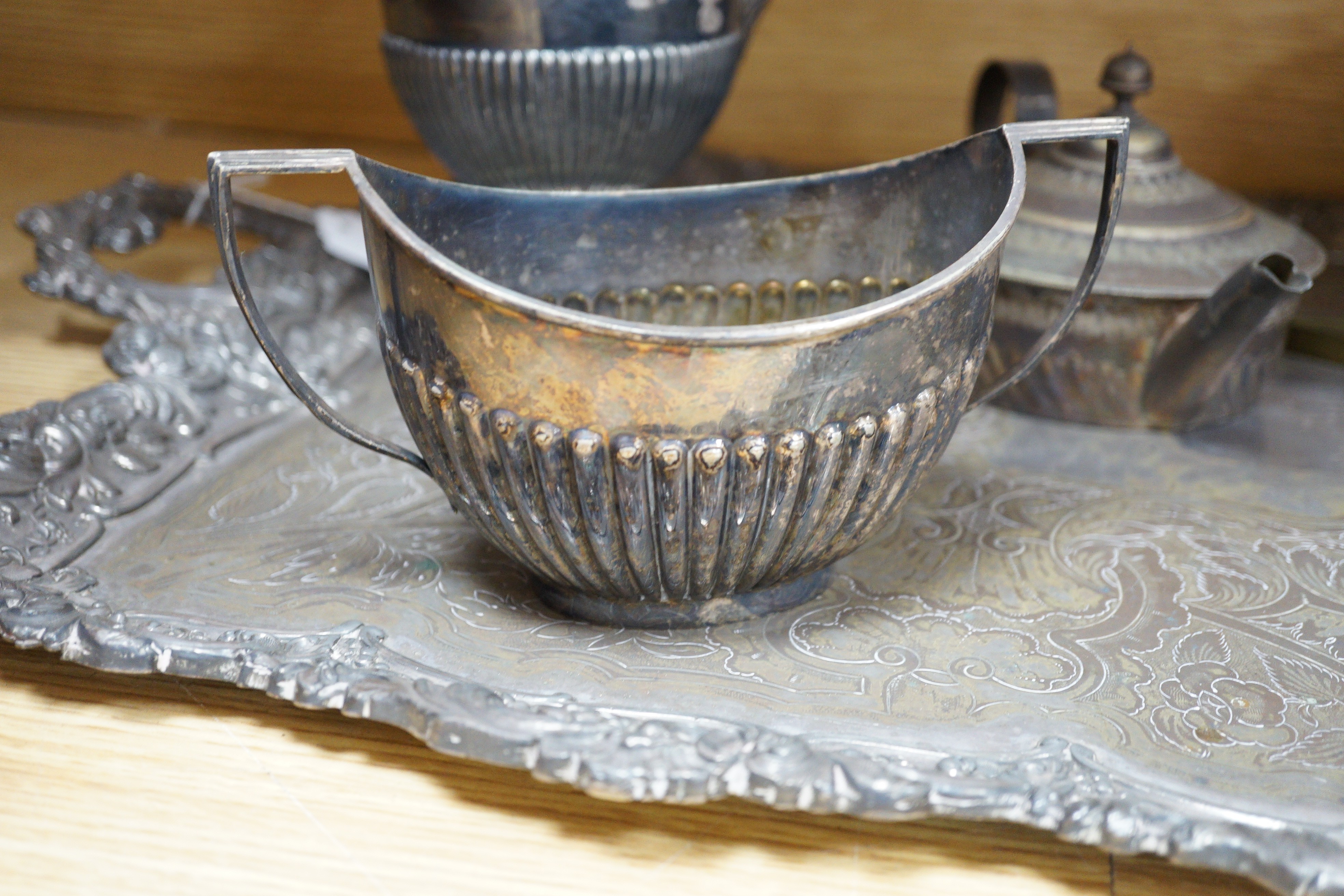 A silver plated two handled tea tray and seven other plated items, tray length 80cm